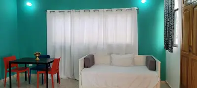 a room with a bed and a table with chairs at Room 3 in Río San Juan