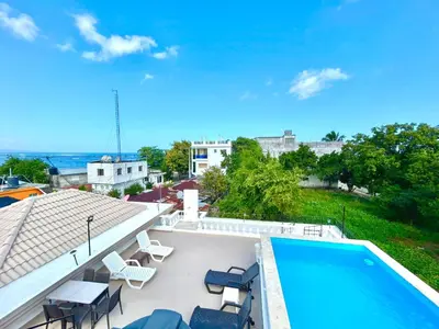 a view of a swimming pool and chairs on a roof at Room 7 in Río San Juan