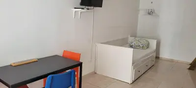 a small room with a desk and a table with a chair at Room 7 in Río San Juan