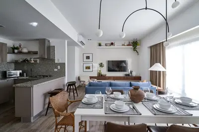 a living room with a table and a blue couch at Regatta Living Suites by Yellowkey in Santo Domingo