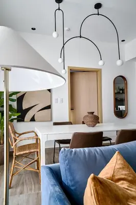 a living room with a blue couch and a table at Regatta Living Suites by Yellowkey in Santo Domingo