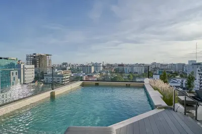 a swimming pool on the roof of a building at Regatta Living Suites by Yellowkey in Santo Domingo
