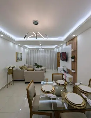 a living room with a dining table and a couch at Escapada perfecta, apartamento frente al mar in San Felipe de Puerto Plata