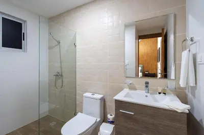a bathroom with a toilet and a sink and a shower at Splendid-KingBed-3BR-Pool-AC-Modern-WiFi-Yellowkey in Santo Domingo