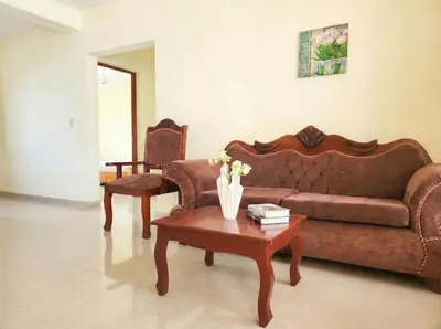 a living room with a couch and a coffee table at 2-Bedroom Beach Apartment with Pool Costambar in San Felipe de Puerto Plata