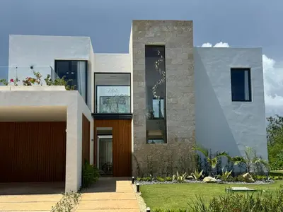 a house with a front entrance with a yard at Golf 218 Playa Nueva Romana in San Pedro de Macorís