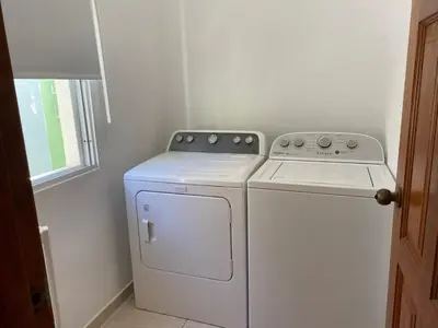 a white washer and dryer in a room at Spacious 2 Bedroom Condo with Pool close to Beach in Punta Cana