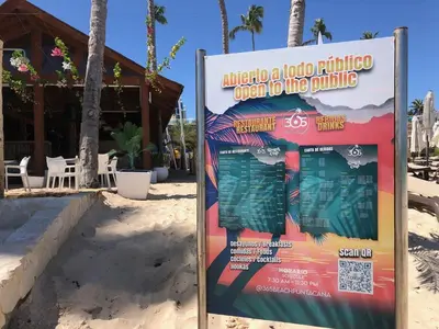a sign in the sand in front of a building at Spacious 2 Bedroom Condo with Pool close to Beach in Punta Cana