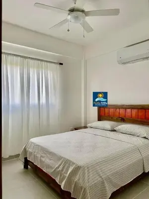 a bedroom with a bed and a ceiling fan at Armonía apartment in Las Terrenas