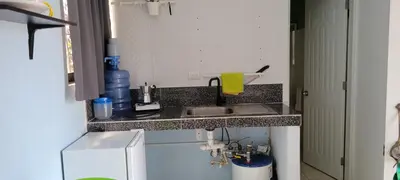 a small kitchen with a sink and a counter top at Room 1 in Río San Juan