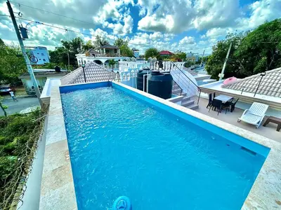 a blue swimming pool on top of a house at Room 1 in Río San Juan