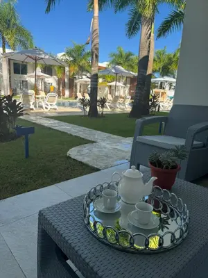 a tray with cups and teapots on a table at Lujoso townhouse en Boca Chica in Boca Chica
