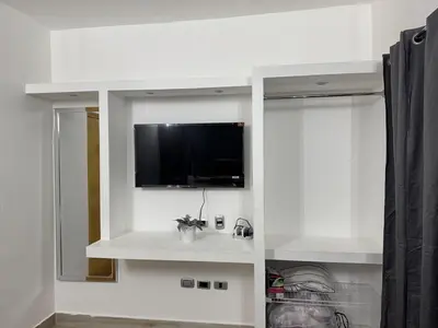 a white bathroom with a tv on a wall at Lujoso townhouse en Boca Chica in Boca Chica