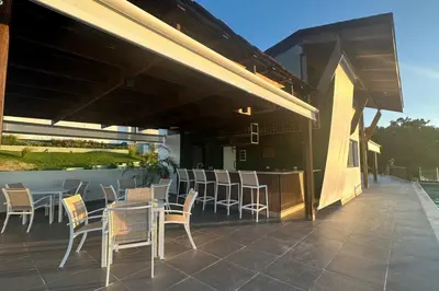 a patio with a table and chairs on a building at Peaceful 2BR 2BA in Bonita with Pool and Palm Tree Views in Las Terrenas