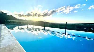 a swimming pool with the sky in the background at Peaceful 2BR 2BA in Bonita with Pool and Palm Tree Views in Las Terrenas