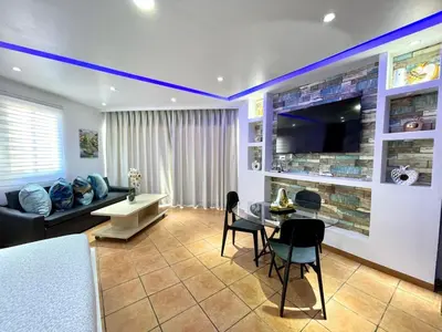a living room with a couch and a table at Sea front apartment, Juan Dolio, San Pedro in San Pedro de Macorís