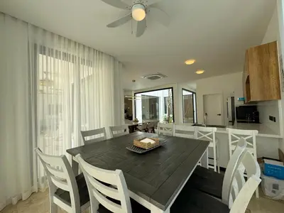 a kitchen and dining room with a table and chairs at Golf 218 Nueva Romana Beach in San Pedro de Macorís