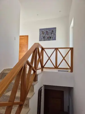 a staircase in a house with wooden railings at Punta Popy 3BR Duplex with Pool, Walk to Beach in Las Terrenas