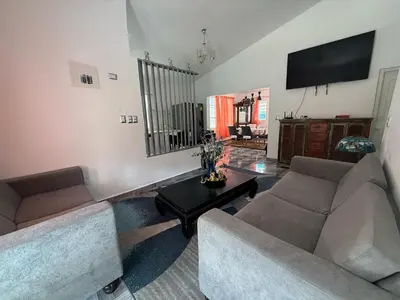 a living room with two couches and a table at Villa Las Tortugas # 2 in Sousa in Sosúa