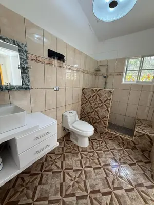 a bathroom with a toilet and a sink at Villa Las Tortugas # 2 in Sousa in Sosúa