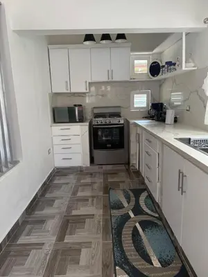 a kitchen with white cabinets and a stove at Villa Las Tortugas # 2 in Sousa in Sosúa