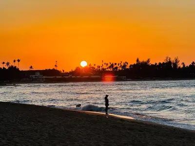 a person standing on the beach at sunset at Romantic Beachfront Retreat In Las Terrenas - Everything You Could Want - 2 Rooms in Las Terrenas