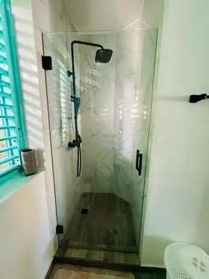 a shower with a glass door in a bathroom at Romantic Beachfront Retreat In Las Terrenas - Everything You Could Want - 2 Rooms in Las Terrenas