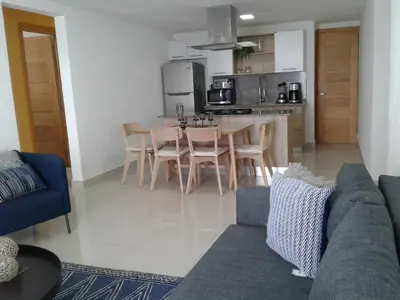 a living room and kitchen with a couch and a table at Apartamento en Boca Chica T1 610 in Boca Chica