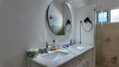 a bathroom with a sink and a mirror at La Fenice Beachfront Apartment in Las Terrenas