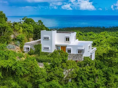 an aerial view of a white house in the forest at Villa Mustique - Perfect tropical paradise in El Limón