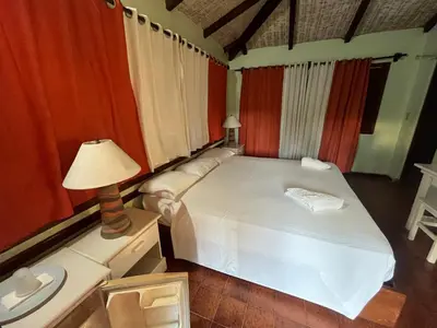 a bedroom with a bed and a lamp on a table at Hotel palococo in Las Terrenas