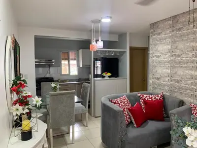 a living room with a couch and a kitchen at Casa Mamá Tere in Pantoja