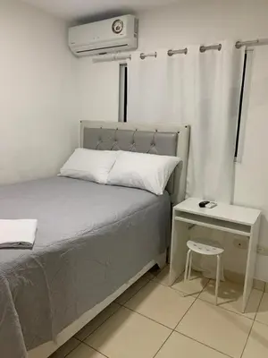 a bedroom with a bed and a nightstand with a bed and a air compressor at Casa Mamá Tere in Pantoja