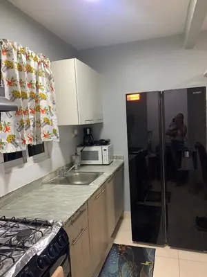 a kitchen with a sink and a microwave at Casa Mamá Tere in Pantoja