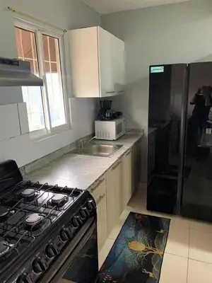 a kitchen with a stove and a microwave at Casa Mamá Tere in Pantoja