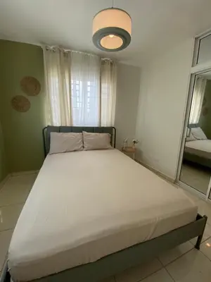 a large bed in a bedroom with a large window at Apartamento acogedor con estilo y piscina in La Romana