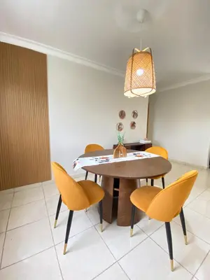 a dining room with a table and chairs at Apartamento acogedor con estilo y piscina in La Romana