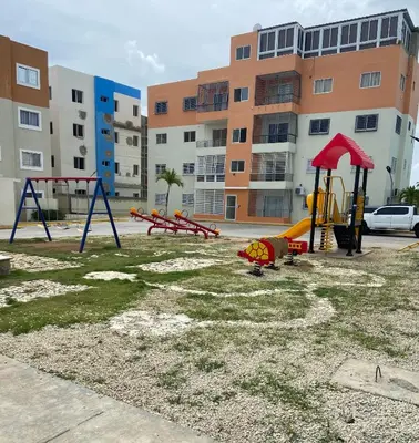 an empty playground in front of a building at Apartamento acogedor con estilo y piscina in La Romana