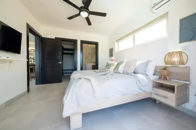 a bedroom with a bed and a ceiling fan at Ocean View, Style, Freedom in Sosúa