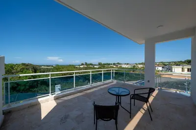 a balcony with two chairs and a table on a balcony at Ocean View, Style, Freedom in Sosúa