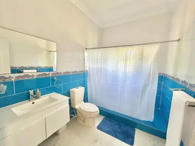 a blue and white bathroom with a toilet and a sink at Villa Rosa 3 Habitaciones Balcones Aire Acondicionado Espacio Ideal Para Tu Familia O Grupo in Río San Juan