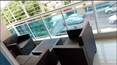 a room with chairs and tables and a large window at Hermoso apartamento 3 habitaciones in Los Paredones