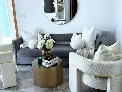 a living room with a couch and a table and a mirror at Family-friendly apartment near the beach in Boca Chica