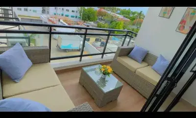 a living room with a couch and a table on a balcony at Residencial JT1 Avenida España in La Viva