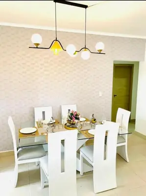a dining room with a table and white chairs at Residencial JT1 Avenida España in La Viva
