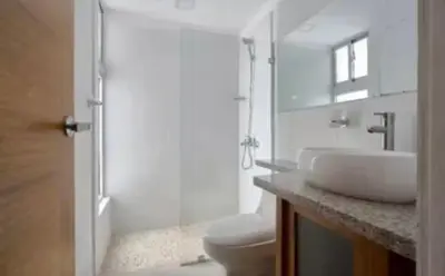 a white bathroom with a sink and a toilet at Encanto en gazcue - Cerca del Malecón y la Zona Colonial in Santo Domingo