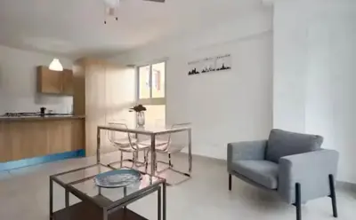 a living room with a couch and a table and a chair at Encanto en gazcue - Cerca del Malecón y la Zona Colonial in Santo Domingo
