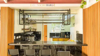 a bar in a room with chairs in a kitchen at Terrenal Paradise in Esperanza