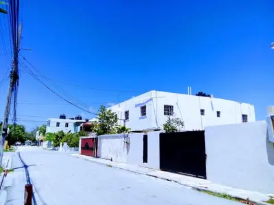 a white building on the side of a street at SML Garden Apartament in La Romana