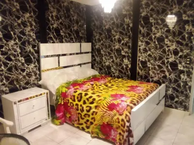 a bedroom with a bed with a leopard print blanket at SML Garden Apartament in La Romana